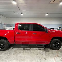 A red truck is parked in a garage.