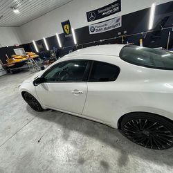 A white car is parked in a garage.