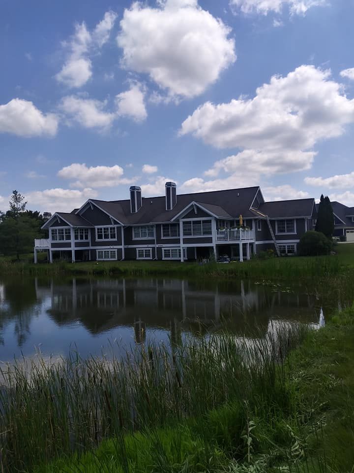 A large house with a pond in front of it