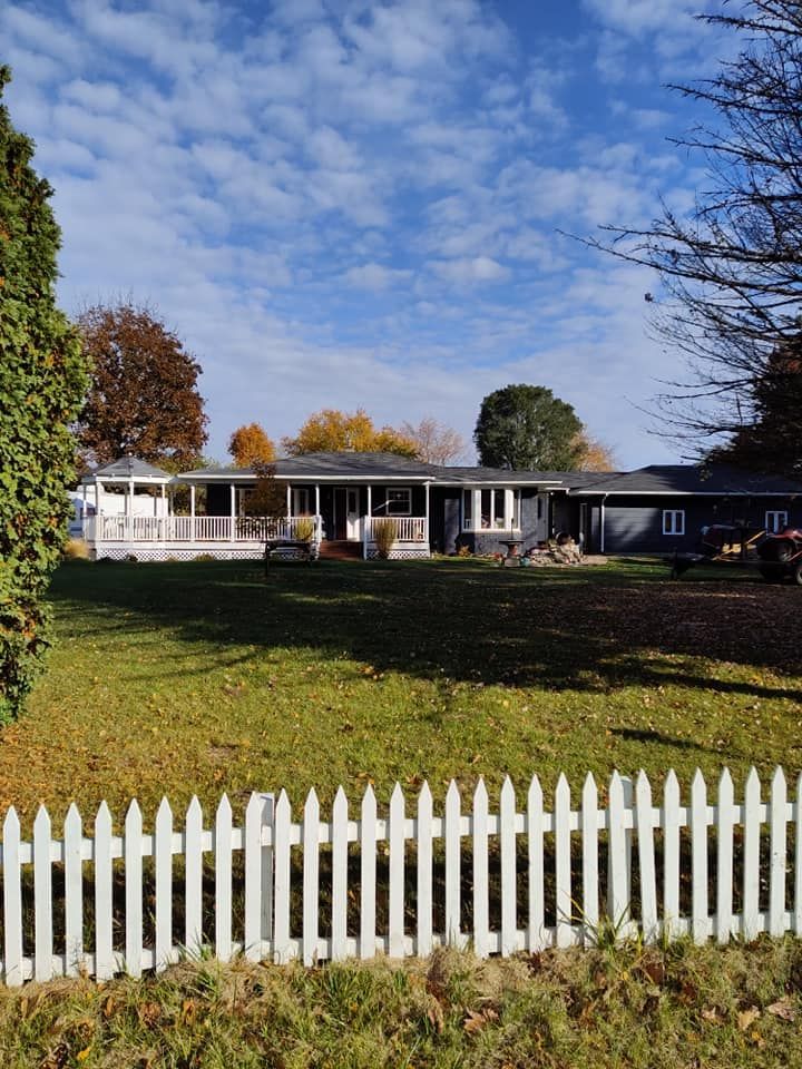 A house with a white picket fence in front of it