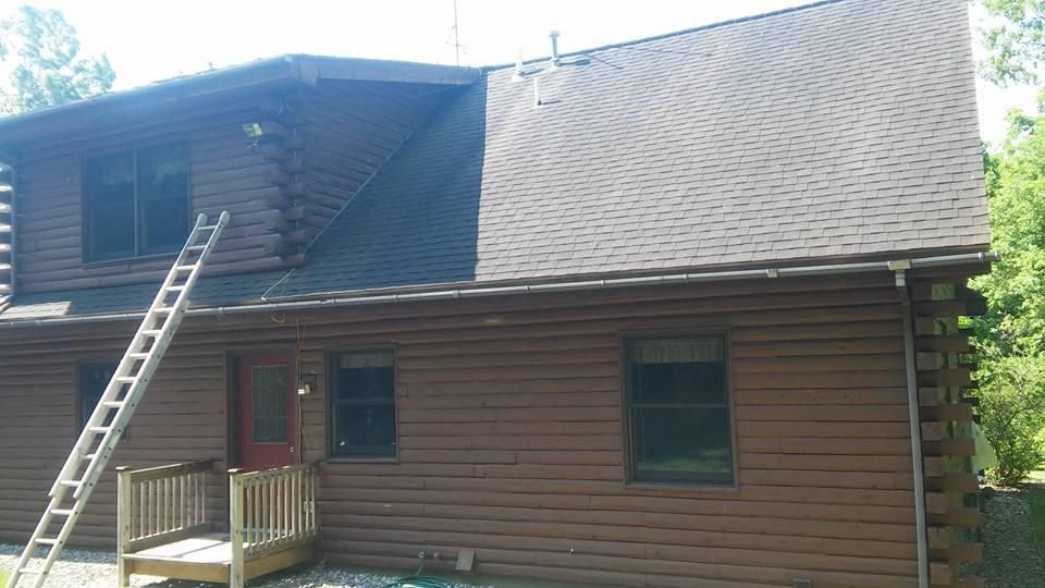 A wooden house with a ladder on the side of it