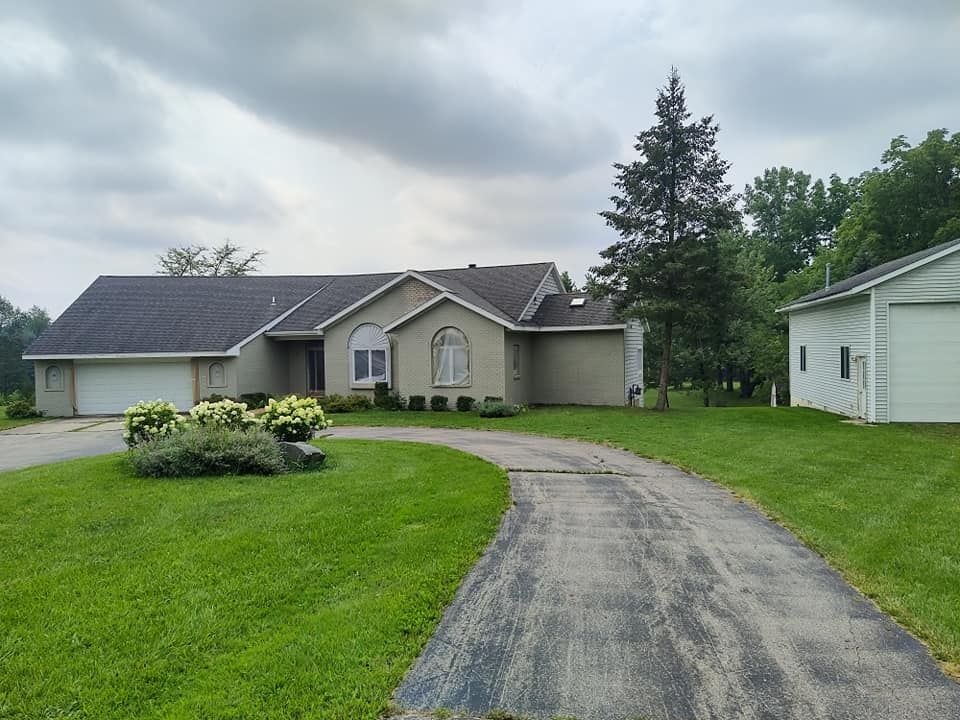 A large house with a driveway leading to it