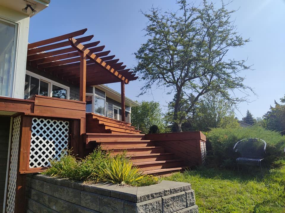 A house with a wooden deck and stairs leading up to it