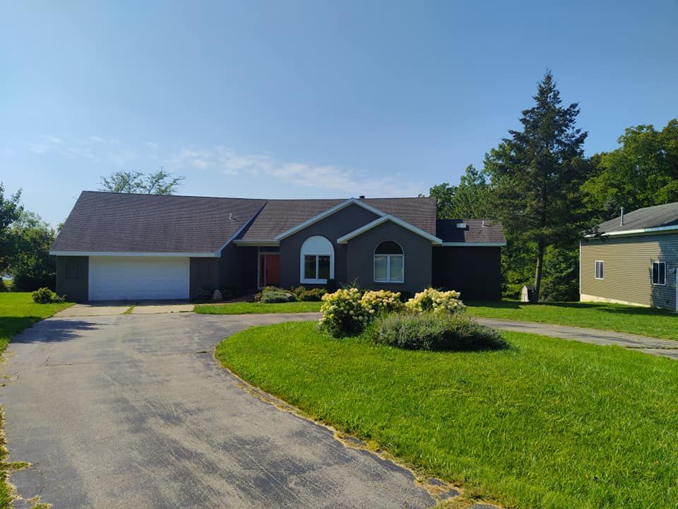 A large house with a driveway leading to it