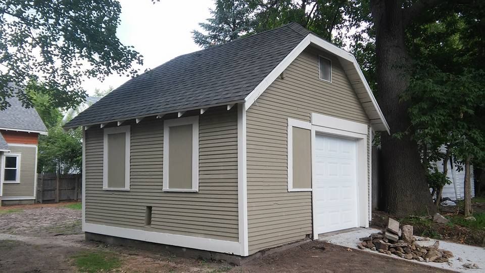 A garage with a white door and a gray roof