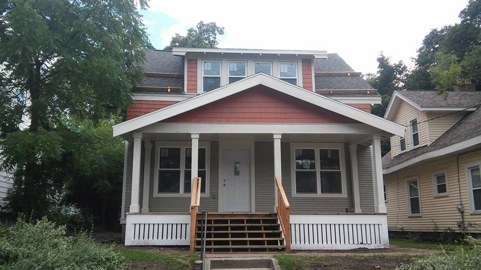 The front of a house with a porch and stairs