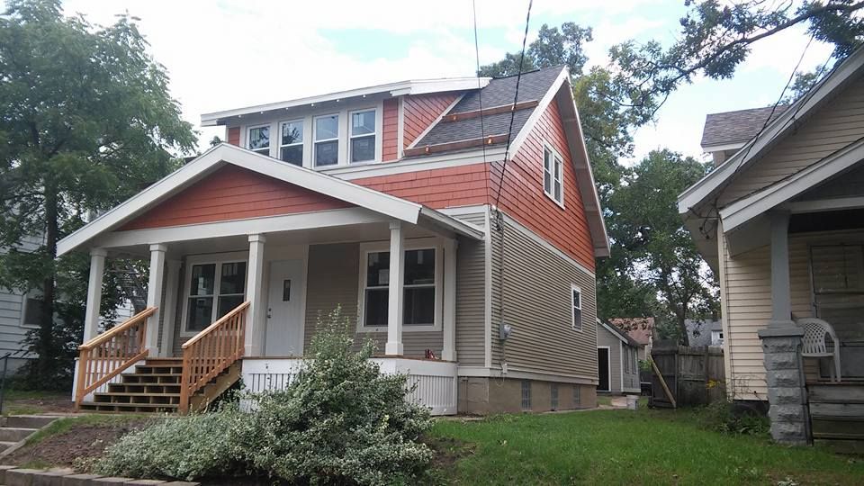 A house with a porch and stairs in front of it