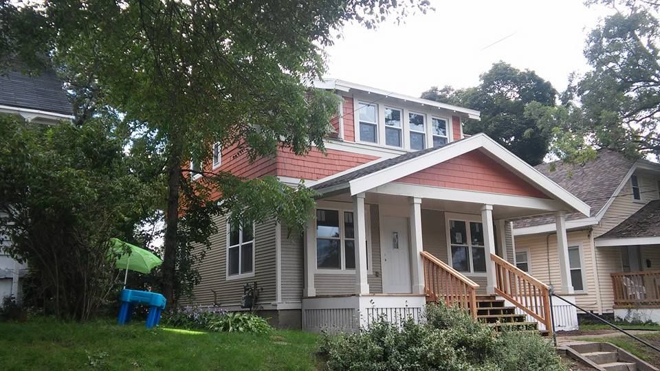 A house with a porch and stairs in front of it