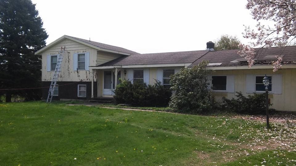 A large house with a ladder in front of it