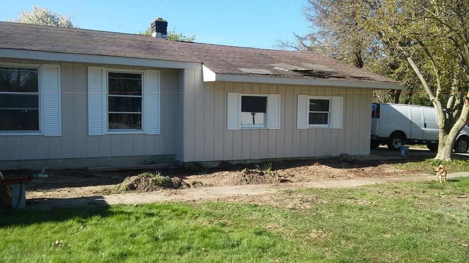 A white van is parked in front of a house
