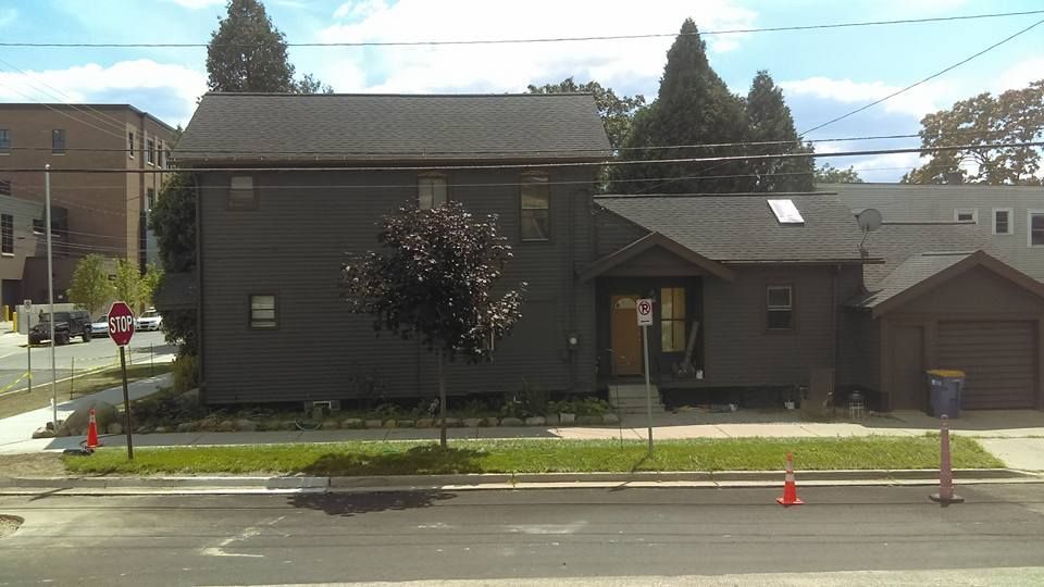A stop sign is in front of a house