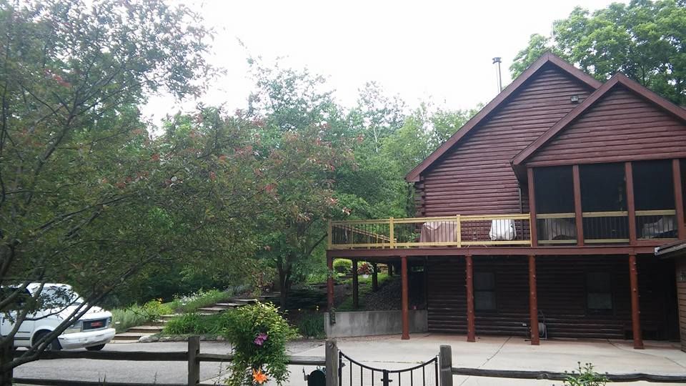 A large wooden house with a screened in porch