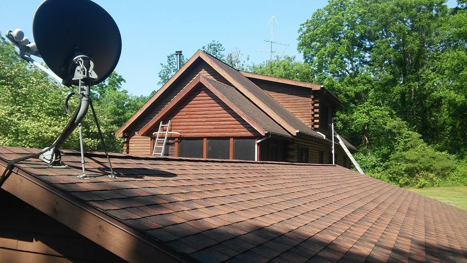 A log cabin with a satellite dish on the roof