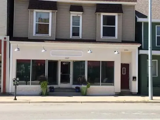A building with a lot of windows and a red door