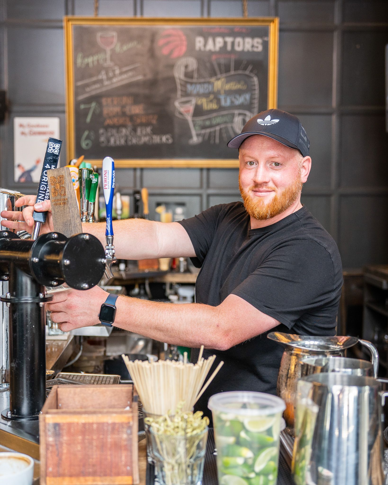 Man pouring beer from bar tap