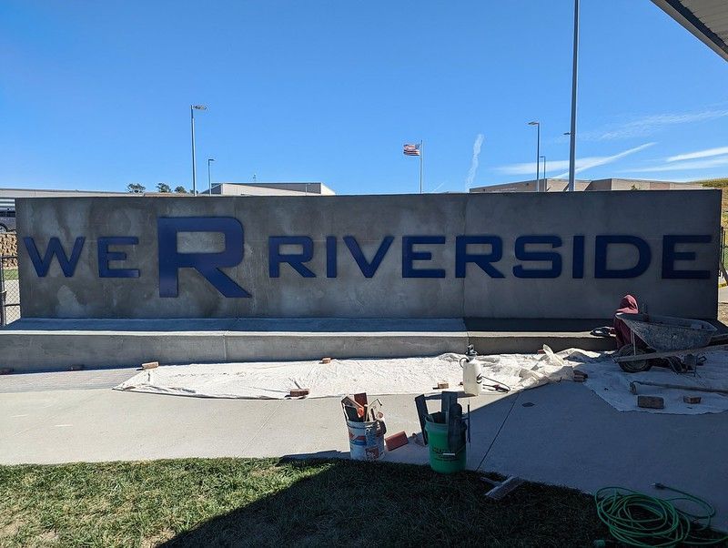 Job location was in Oakland, Iowa for Riverside School. 
We had to grind down and attempt to smooth out the poured concrete wall. Then we applied galvanized wire lath and 3 coats of traditional stucco and a knock down finish coat.