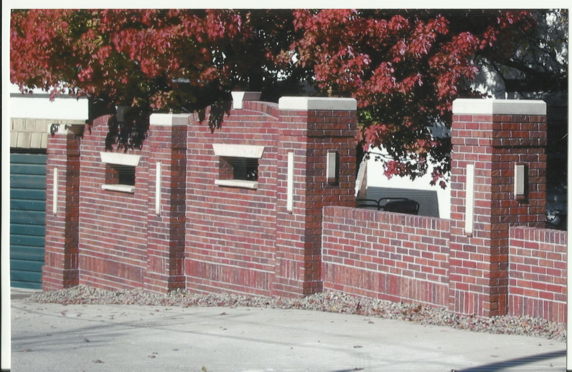 This was a very fun Brickwork project . We build a custom brick fence with lots of hand carved stone caps and ribbons and even some quoins . located in the Dundee area in Omaha, Nebraska
