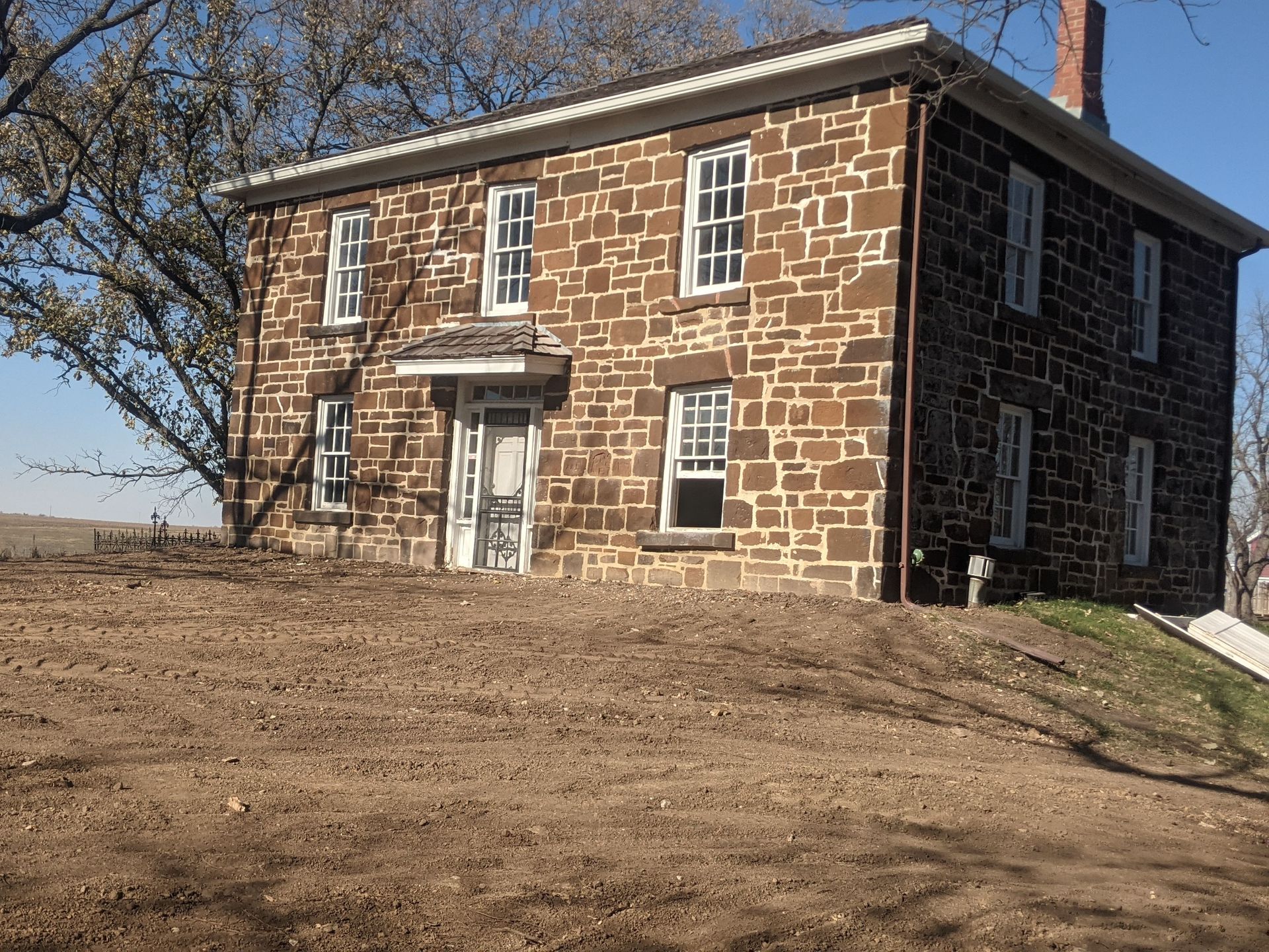 We tackled this historic underground railroad house in Lewis Iowa know as the George B Hitchcock House.  We had to fix a failing limestone foundation and rebuild it with limestone quarried from a local quarry . We also had to underpin the house and install I-beams to support the load of the home as we completed the foundation work . It was a very fun historic preservation job . After the foundation wall was completed we had to replace the stone that we had to remove for the supports and put back into the original places and tuck-point . We even had to carve and replace a large entry stone on one side of the home.