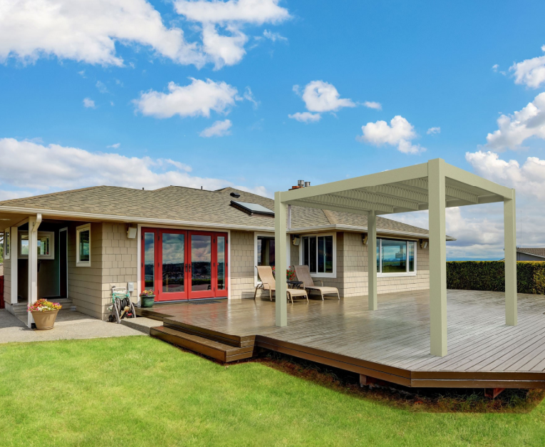 A house with a large deck and a pergola in front of it.