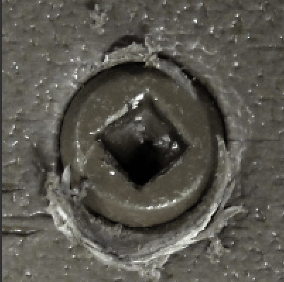 A close up of a screw with a square hole in it