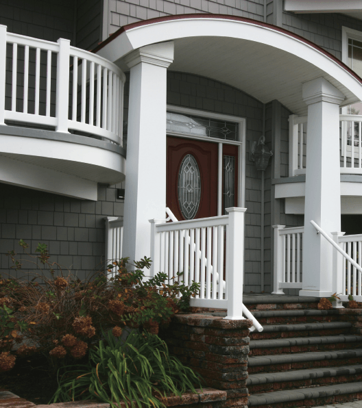 A house with a red door and white railing
