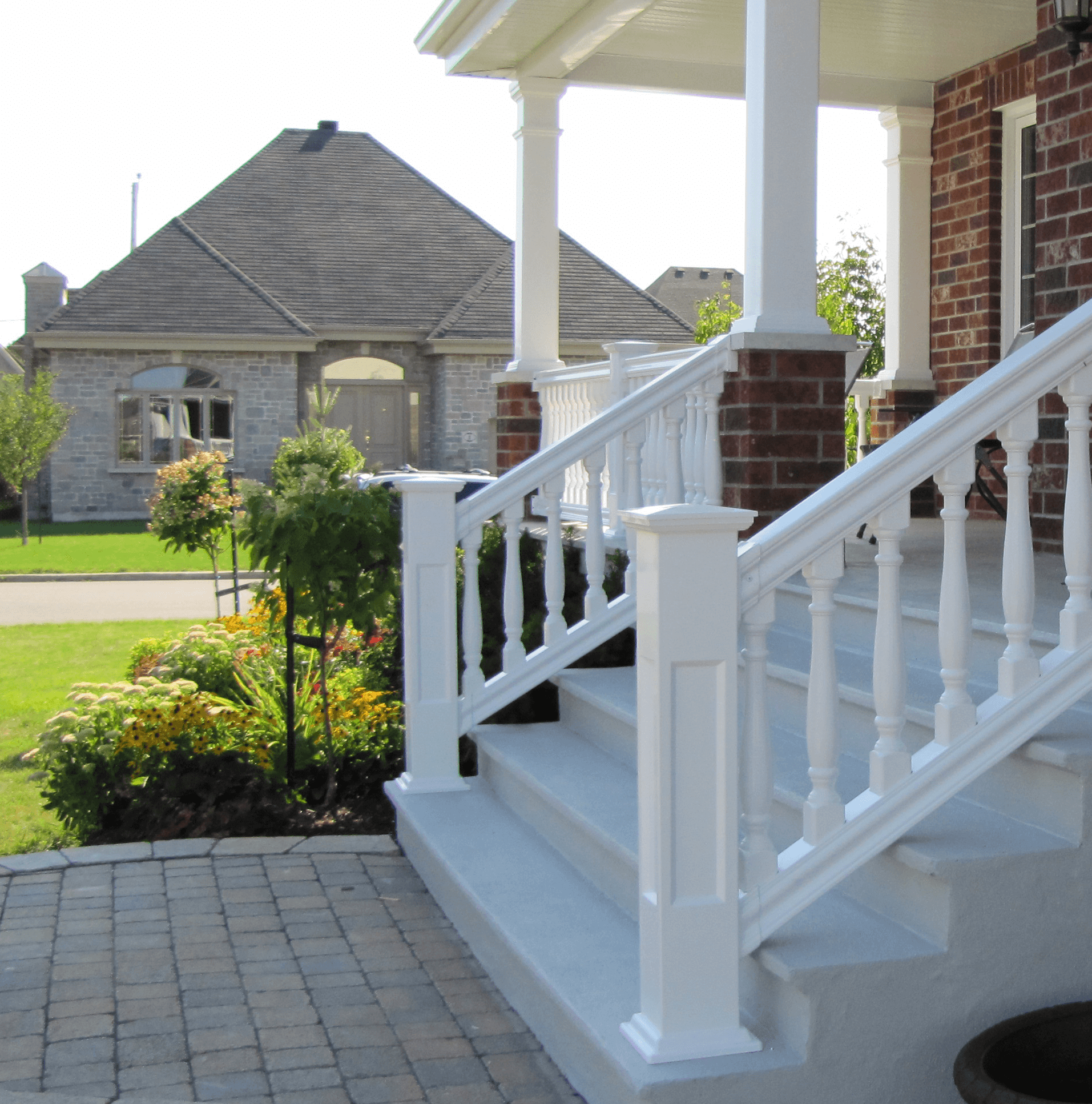 A brick house with white stairs and a white railing