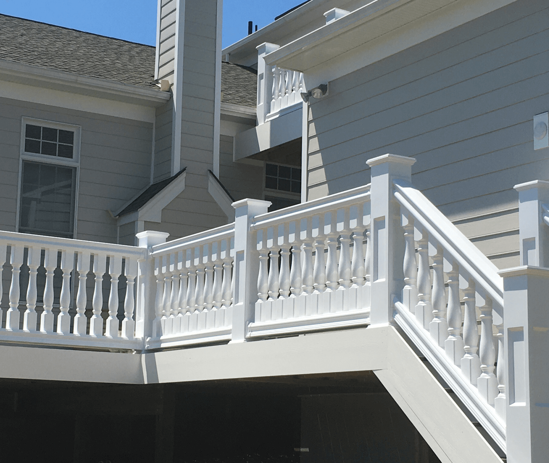 A white railing on the side of a house