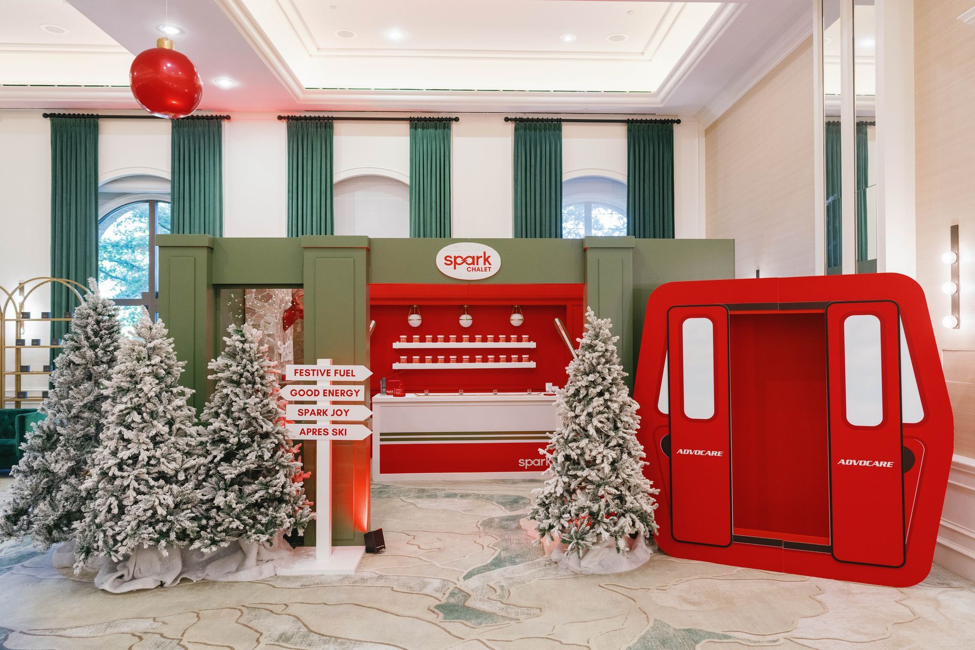 A festive winter scene with a red ski lift, snowy trees, and signpost; a holiday display.