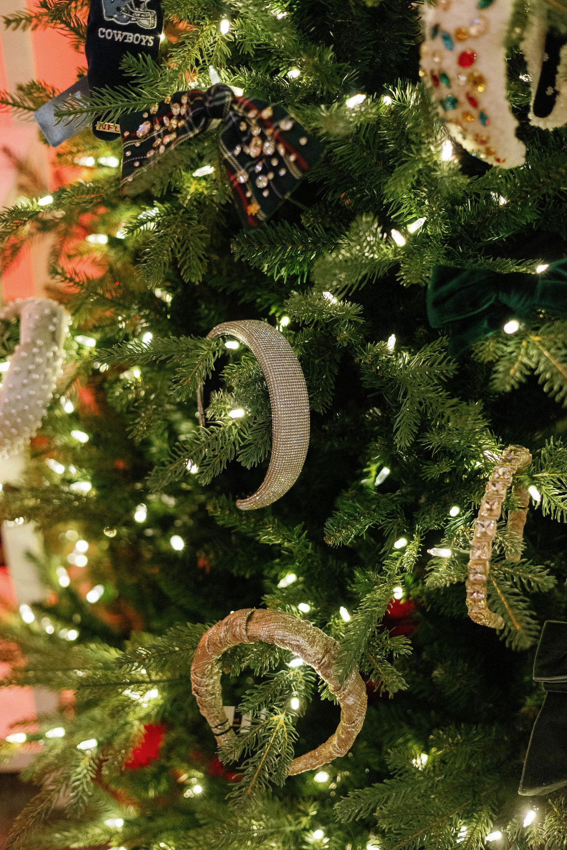 Christmas tree decorated with seahorse ornaments and white lights.