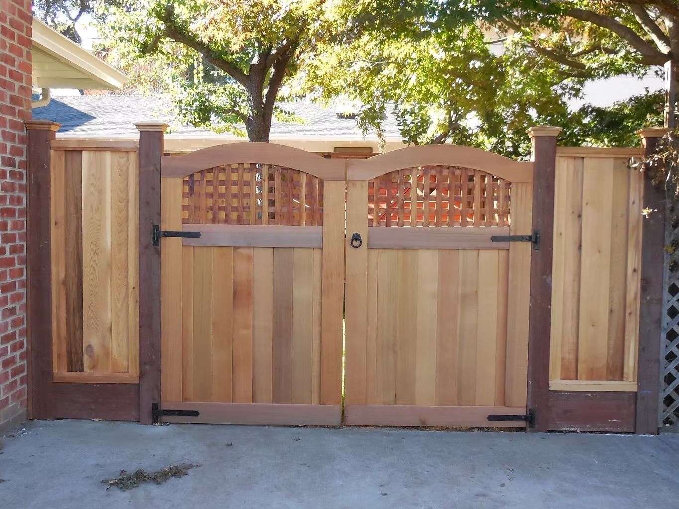 A white picket fence is surrounded by plants in a garden.
