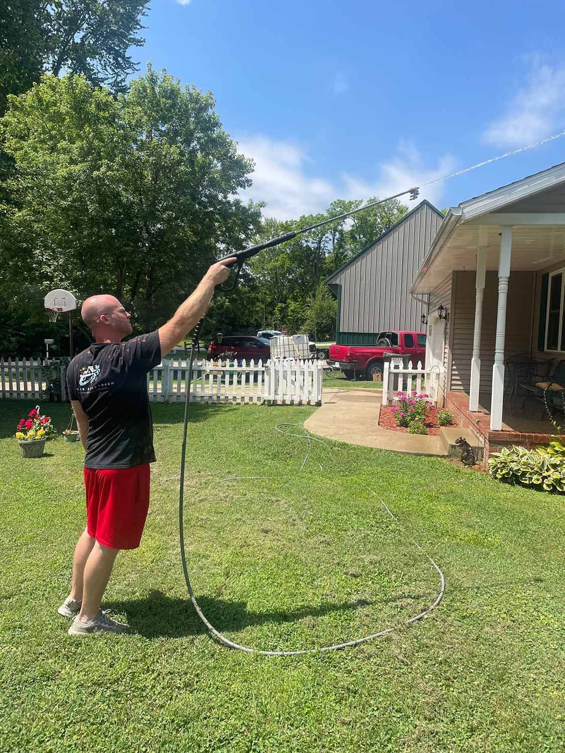 Worker Cleaning the Gutter