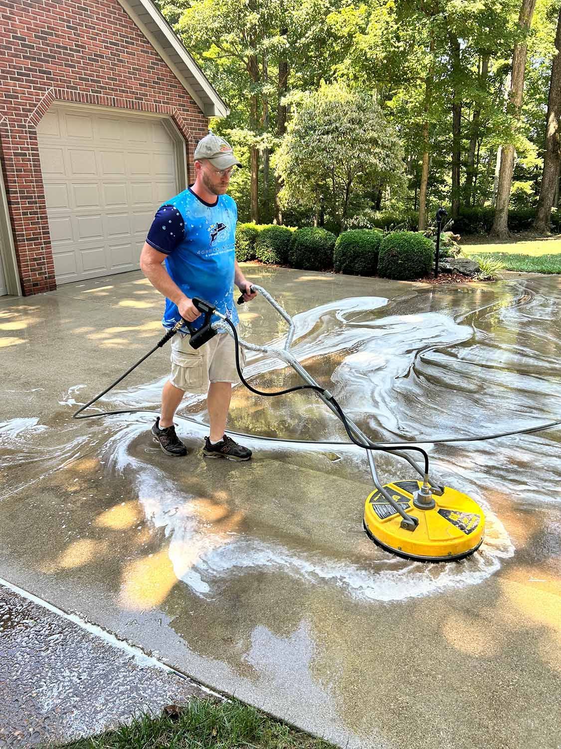 Worker Cleaning the Driveway