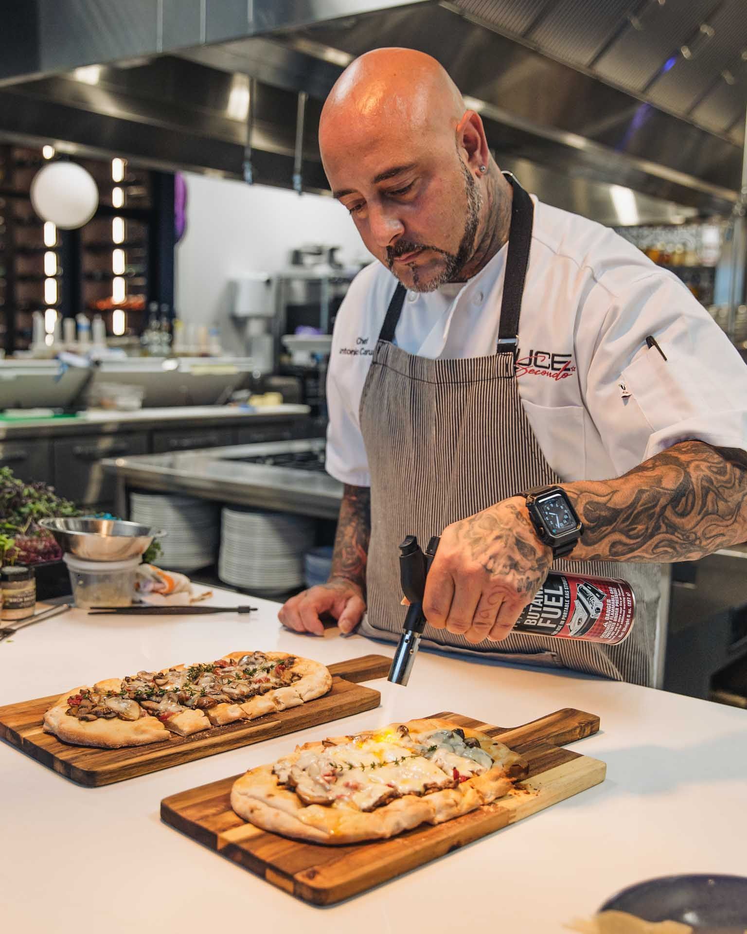 tony wearing an apron with the word chef on it