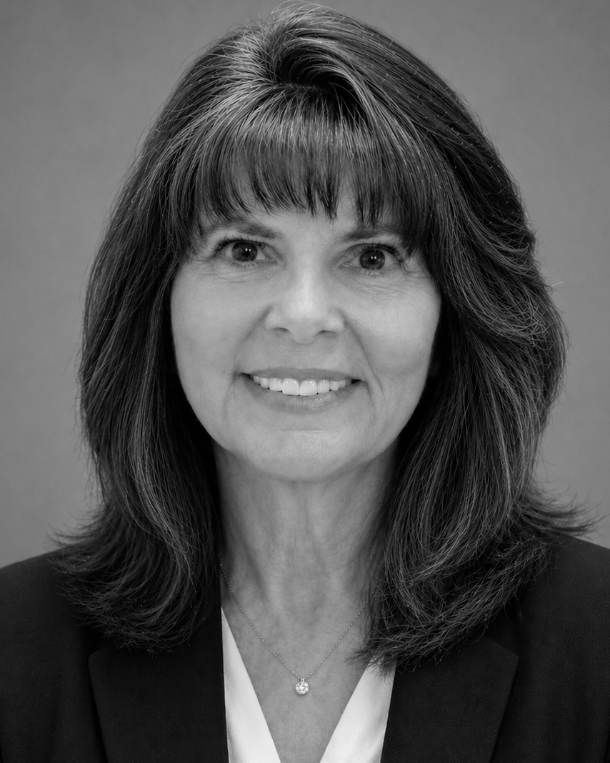 A woman is smiling in a black and white photo