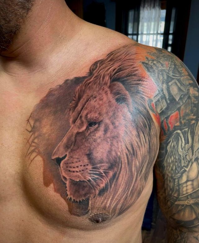 Zuez lion bravery pain and hurt tattoo idea | TattoosAI