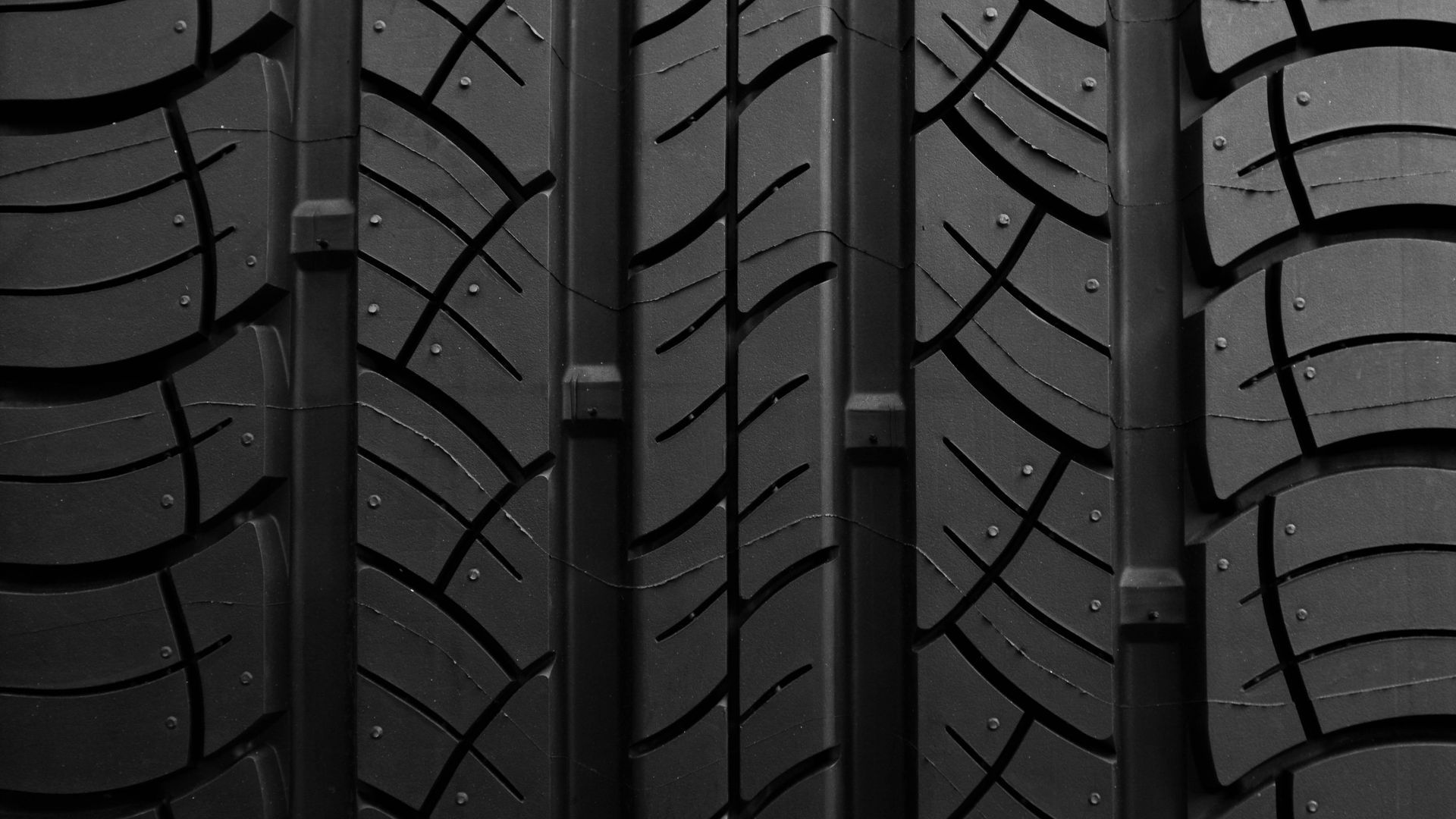 A close up of a tire with a screw in it.