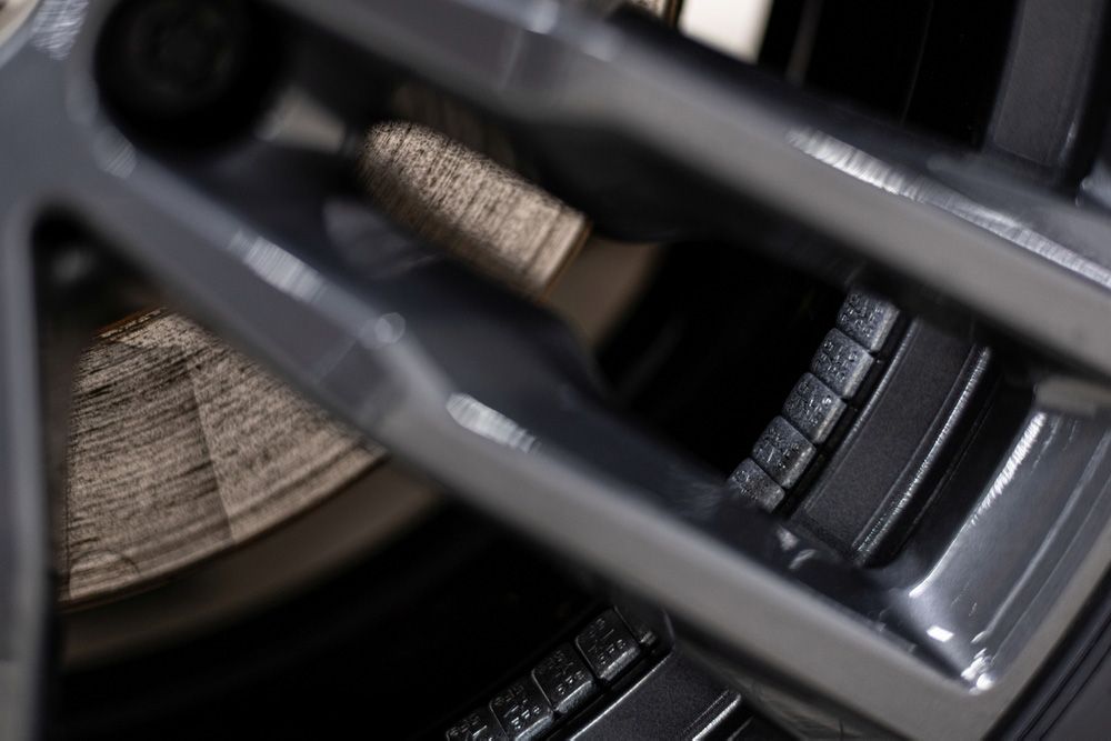 A man is holding a gas can on the side of the road.