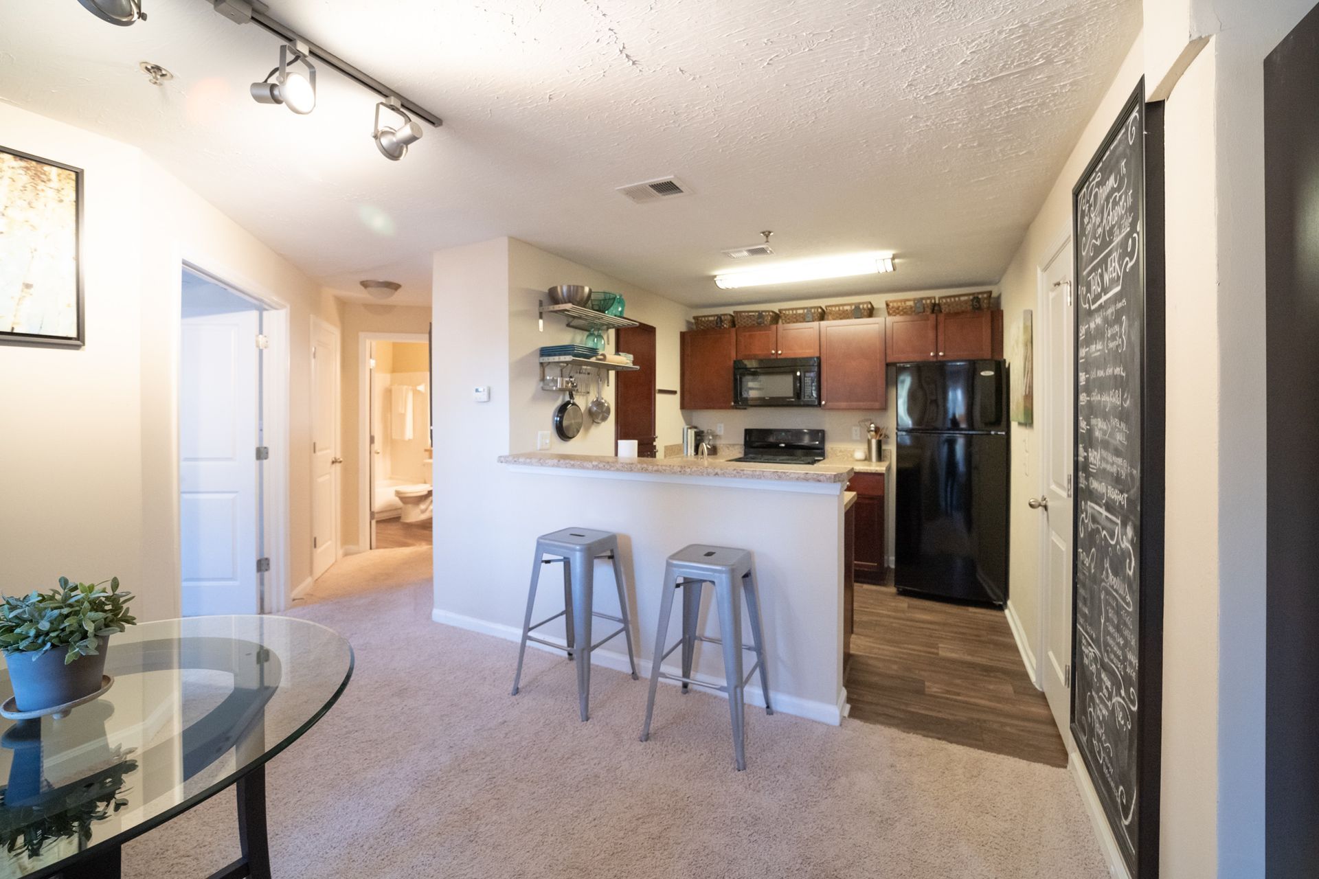 A living room with a white chair and a lamp