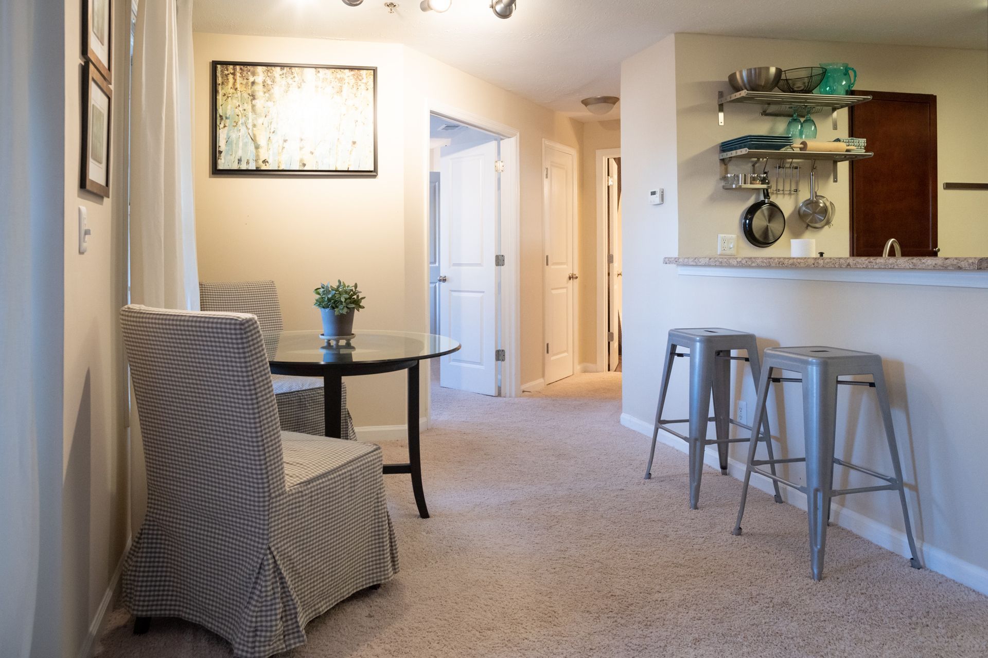 A living room with a table and chairs and stools