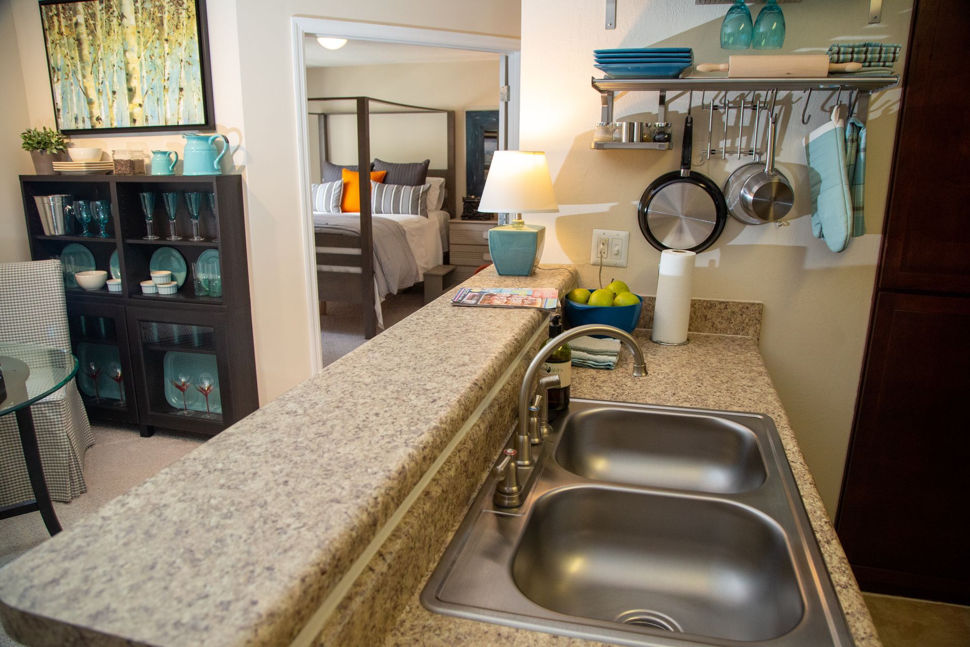 A kitchen with two sinks and a stainless steel faucet.