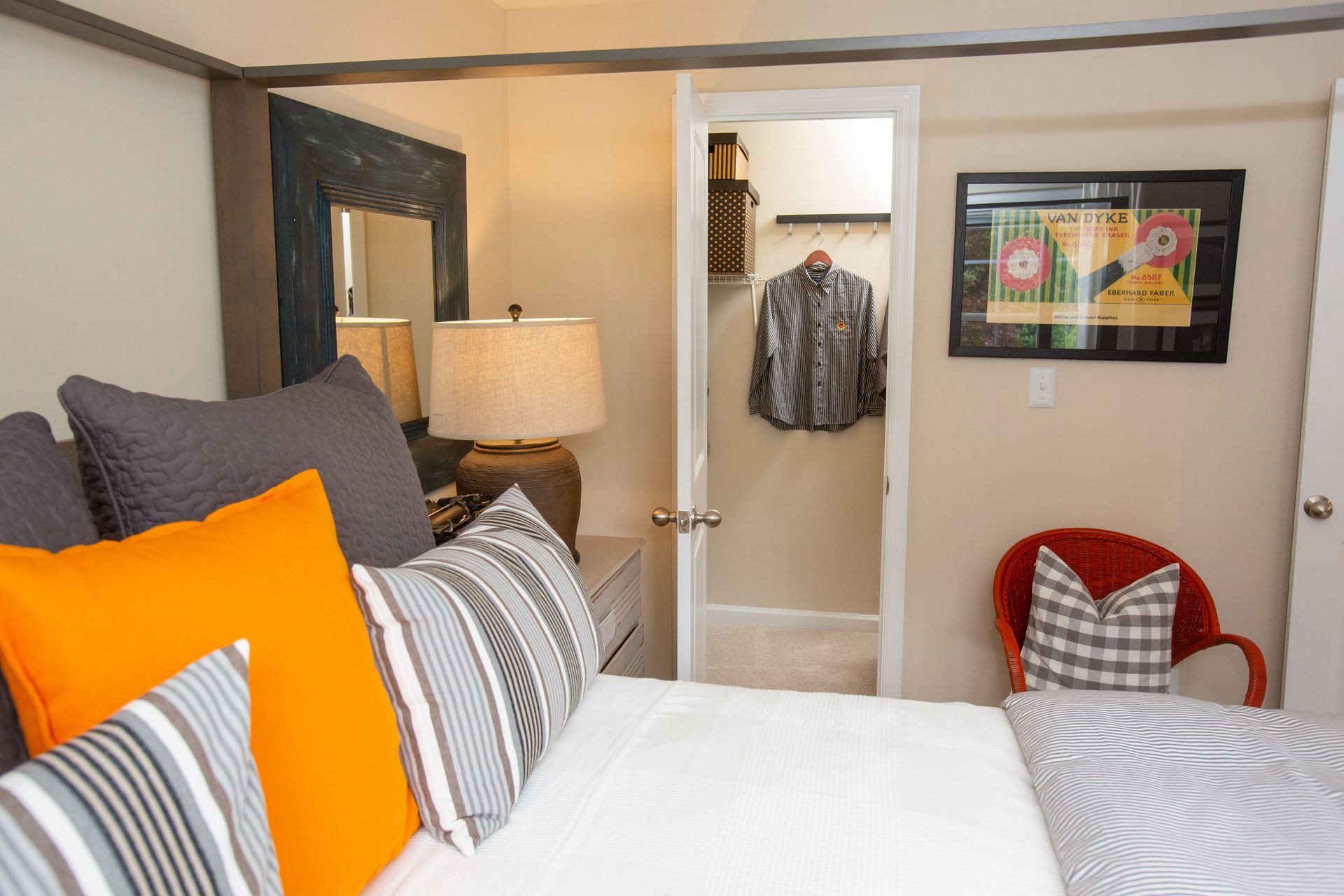 A bedroom with a large bed and a walk in closet