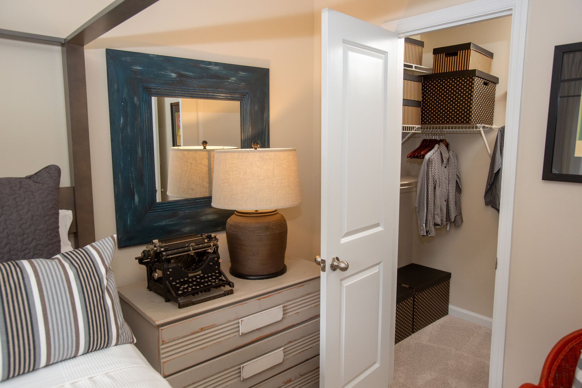 A bedroom with a canopy bed and a walk in closet