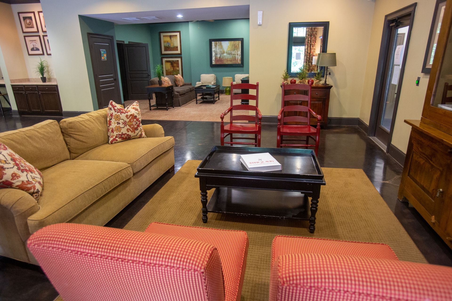 A living room with a couch , chairs and a coffee table