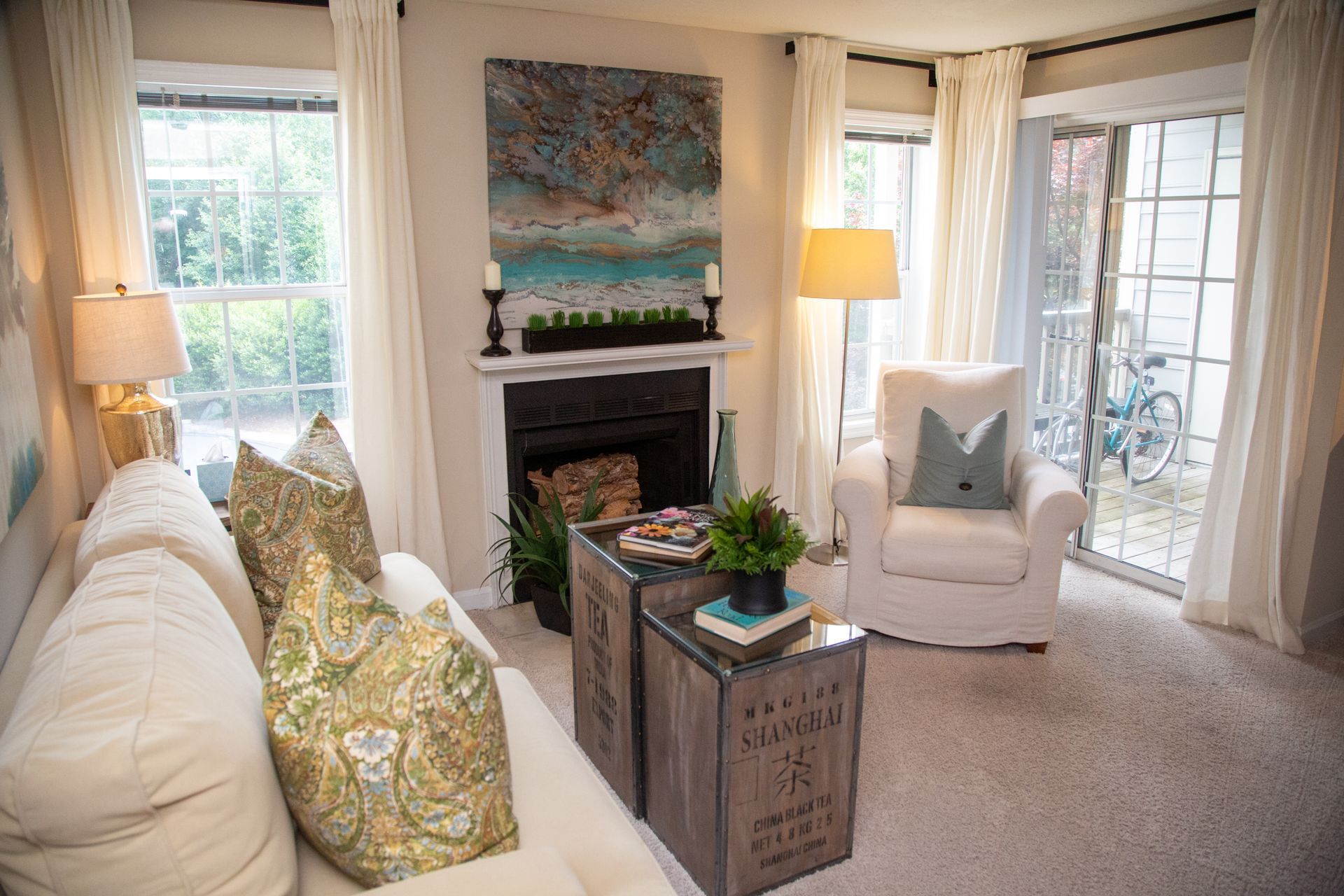 A living room with a couch , chair , coffee table and fireplace.