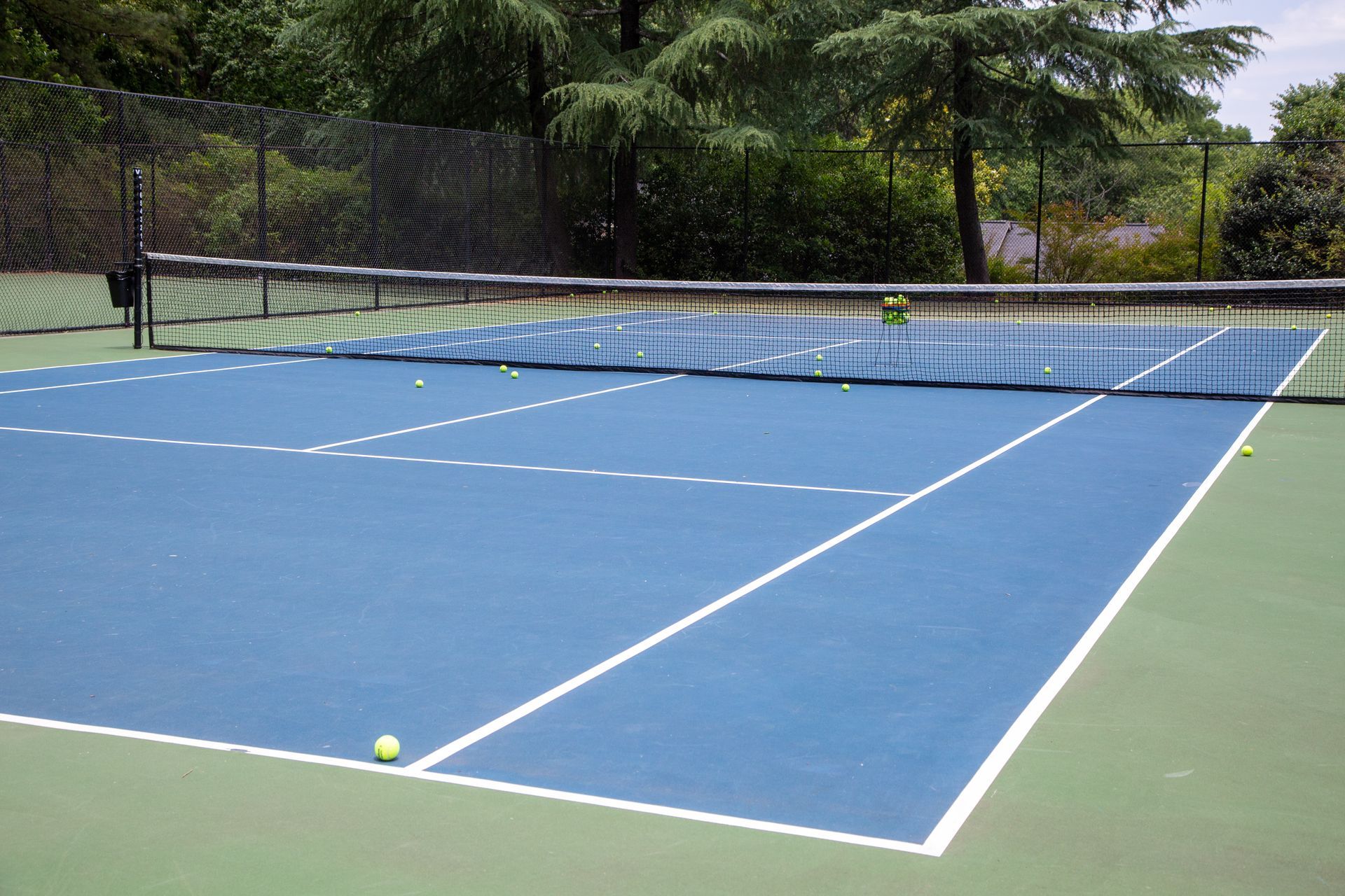 A tennis court with a net and a ball on it