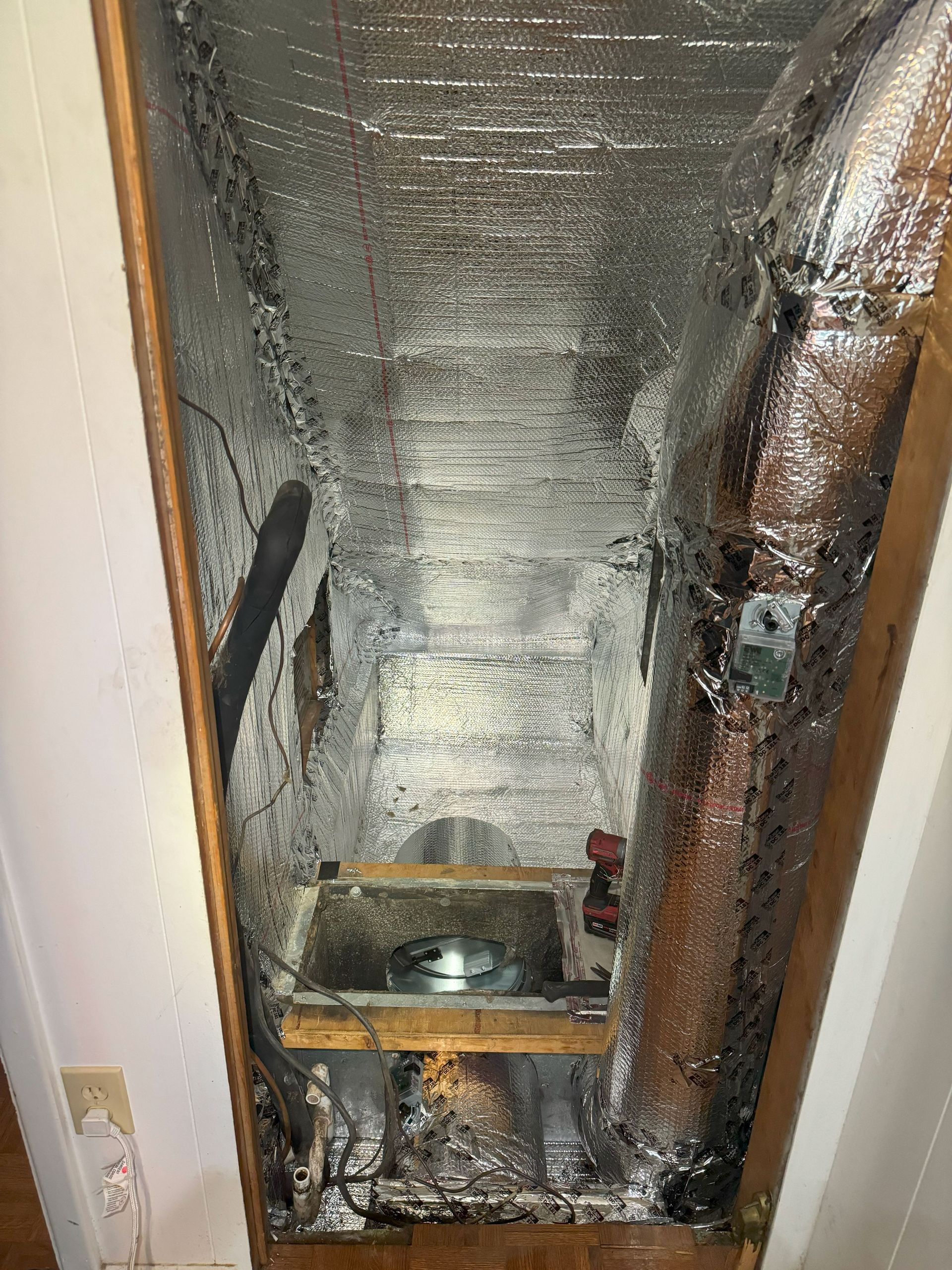 A room with a lot of aluminum foil on the walls and ceiling.