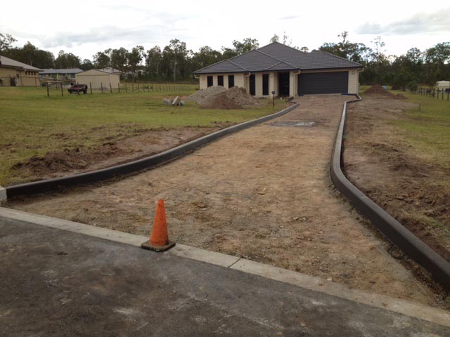 dirt driveway with kerbs