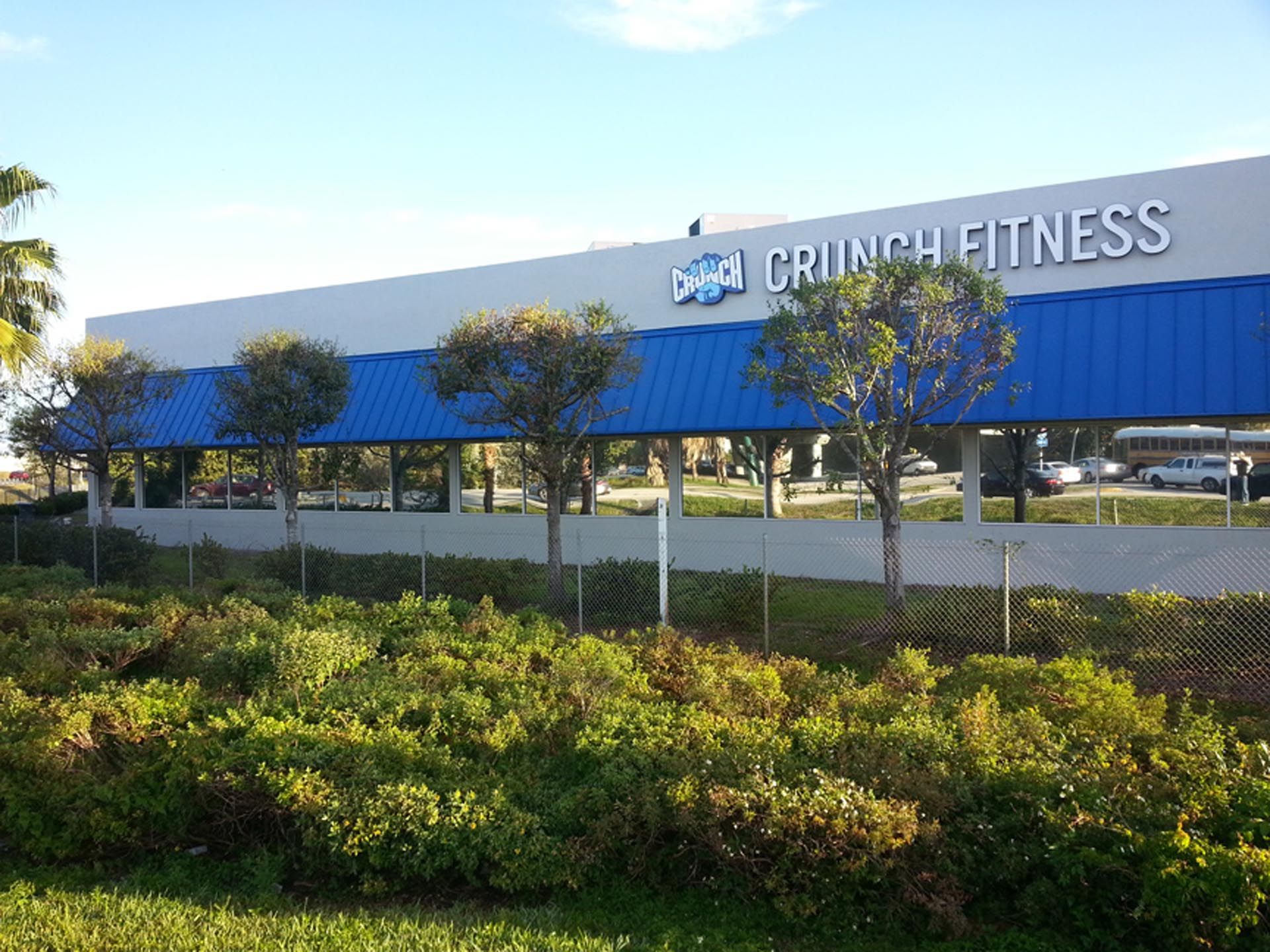 A crunch fitness building with a blue roof