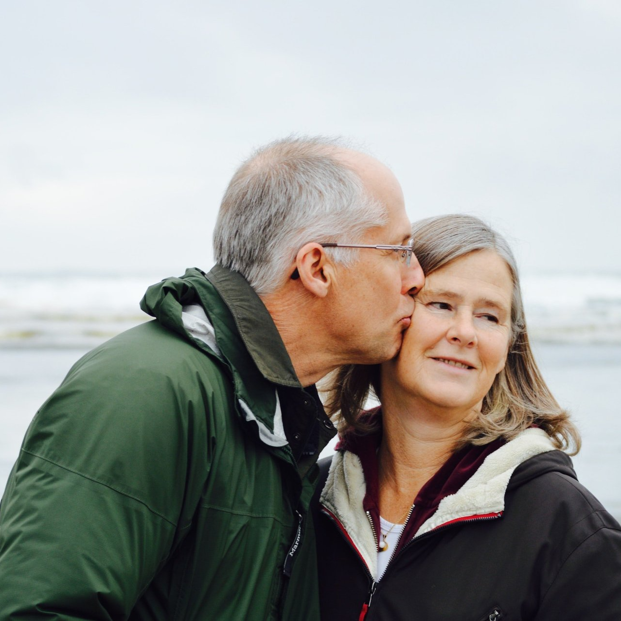 elderly man kissing his wife