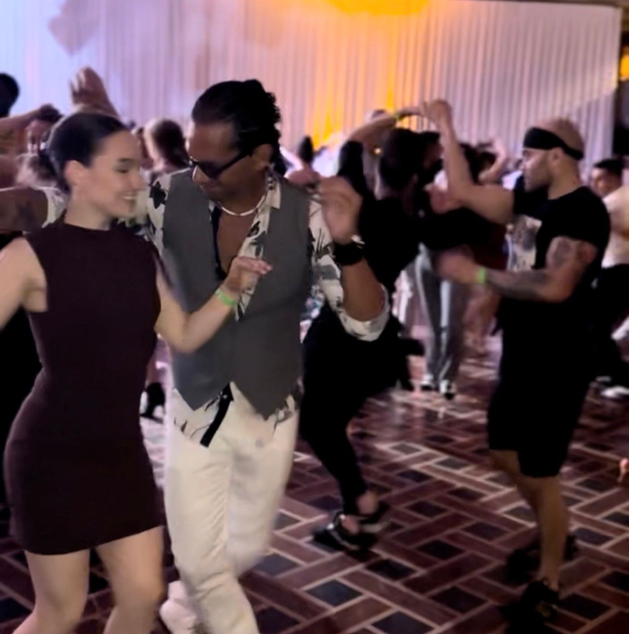 A man is holding a woman in his arms while dancing.